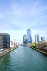 Fototapeta na wymiar Osaka skyline along with Neya river (Neyagawa) in Japan . Panoramic view. - 日本 大阪 寝屋川 大阪のビル群 水上バス 