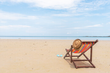 Empty beach chair on the beautiful sand beach under the clear blue sky