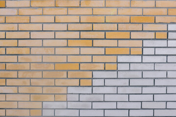 Brick wall. Red and white bricks. The horizontal part of the wall is made of white and yellow bricks. Brick background. Construction and interior concept