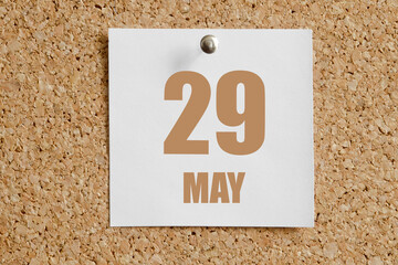 may 29. 29th day of the month, calendar date. White calendar sheet attached to brown cork board.Spring month, day of the year concept