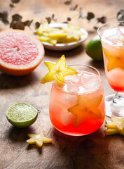 Alcohol cocktail with carambola, grapefruit and lime.