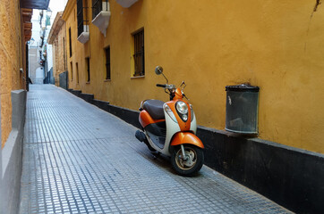 Naklejka na ściany i meble Motorbike in the narrow street of European town