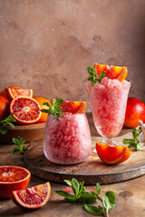 Homemade Italian Granita Dessert with blood orange, elderflower, rose wine  in serving glasses.