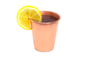 Copper cup with water and lemon on white background