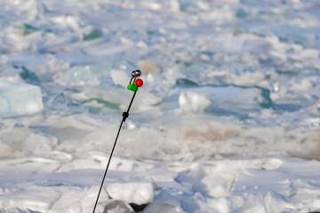 fishing rod for winter fishing in a hole on the river