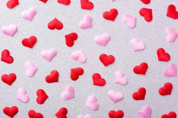 Many red and pink hearts on a white background. Top view, close up, isolated.