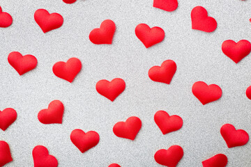 Top view and close up of many red decorative hearts on a white background. Concept of love,...