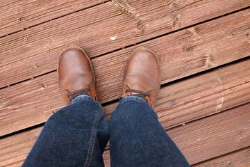 Feet in red shoes on a red wood floor