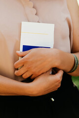 a book in the hands of a young beautiful girl