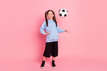 Full length body size photo of schoolgirl in sport outfit throwing ball in air smiling isolated...
