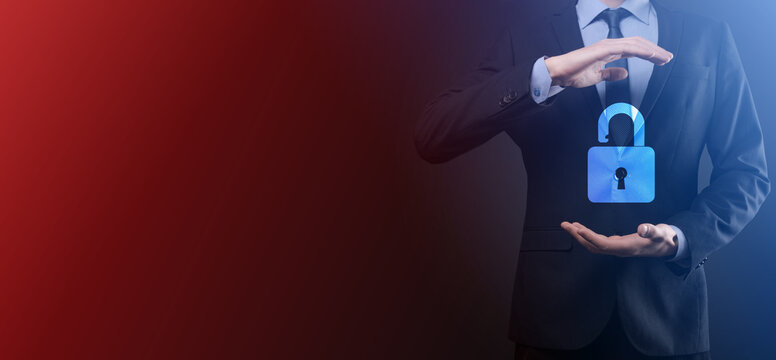 Businessman holds an open padlock icon on his palm.unlocking a virtual lock. Business concept and technology metaphor for cyber attack, computer crime, information security and data encryption.