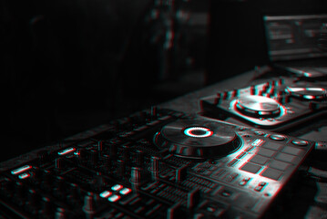 Fototapeta na wymiar DJ console for mixing music with blurry people dancing at a nightclub party. Black and white with 3D glitch virtual reality effect