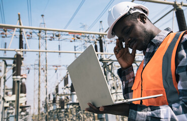 Handsome engineering man using laptop projects plan and have serious face in front of High power...