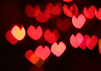 Bokeh background of colorful hearts at night