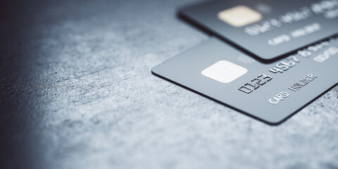 Online payments concept with black credit cards on abstract blank dark surface, 3D rendering, mock...