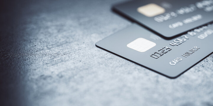 Online payments concept with black credit cards on abstract blank dark surface, 3D rendering, mock up