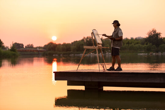 Mature man painting in park