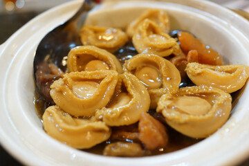 Chinese cuisine braised abalone with mushroom and sea cucumber in a clay pot.