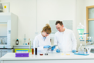 Two scientist working with tablet in CBD hemp laboratory