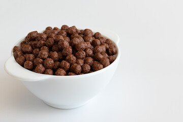 chocolate cereal in bowl isolated on white background