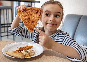Little girl with a piece of delicious cheese pizza.