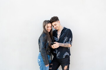 Couple looking at mobile on white background