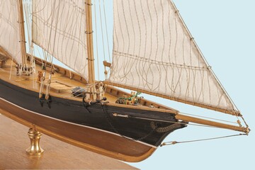 Handmade model sailing ship. Beautiful Handmade model sailboat of America New York 1851 isolated on blue background. 