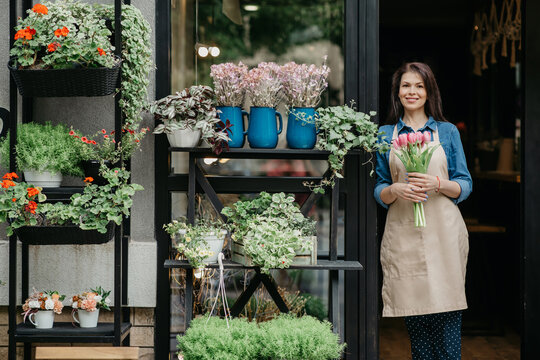 Woman florist reopening shop after covid-19 pandemic, delivery service for clients