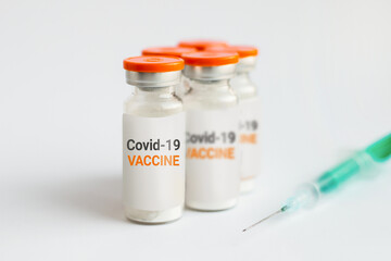 Coronavirus vaccine close up. Ampoules and syringe on a white background