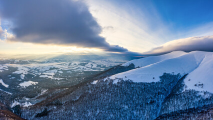 Aerial view of the mystical landscape of a winter mountain forest on a cloudy frosty day. The concept of the harsh beauty of the Nordic countries. Copyspace