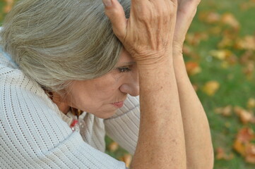 Fototapeta premium sad senior beautiful woman in park