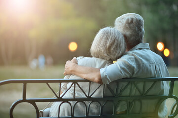 senior couple on bench in the city park