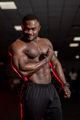 Fototapeta na wymiar Athlete doing exercise for biceps. African athlete in the gym.