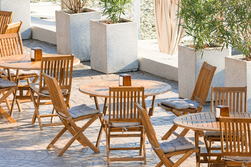 An empty outdoor cafe with no people during the covid-19 pandemic. ..