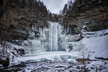 Taughannock Falls, a 215-foot (66 m) plunge waterfall that is the highest single-drop waterfall east of the Rocky Mountains, forms icles during a winter day.
