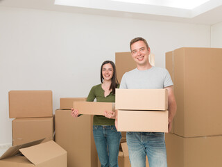 couple moving in carrying boxes
