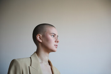 Portrait of young bald woman looking aside. 