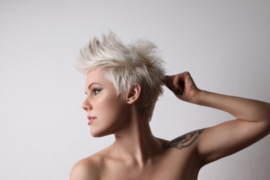 Portrait of beautiful blond young woman with short hair. Studio shot.