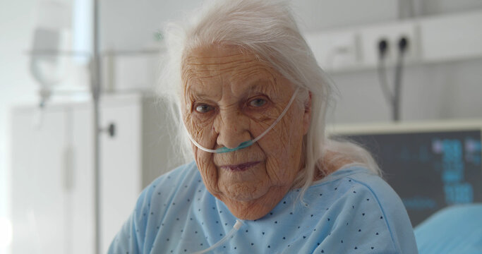 Senior Woman Sitting On Hospital Bed And Looking At Camera