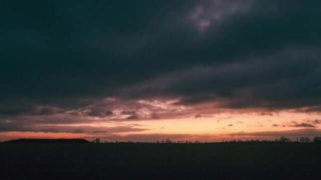 Dark time lapse sunset with clouds