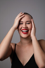 Portrait of a happy, beautiful and bald woman, vertical shot.