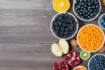 Mix of fresh berries, nuts and fruits. Healthy food contains a lot of vitamins and useful trace...