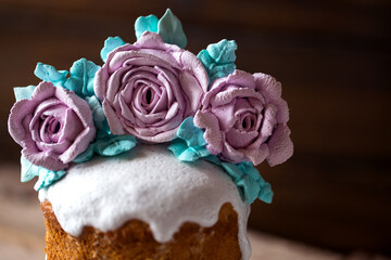 easter cake decorated with roses meringue flowers on a dark background