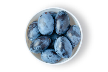 Plum. Ripe berries in a white plate. Isolated on white
