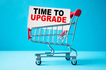 a business card with text TIME TO UPGRADE in a shopping cart. business and finance