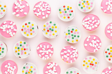 Fototapeta na wymiar Colorful cupcakes on a white background.