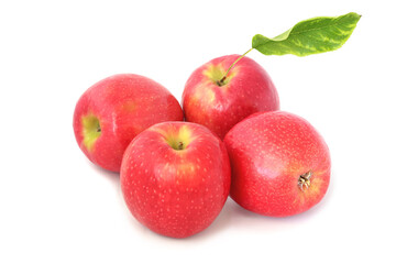 Four ripe red apples with leaf isolated on white