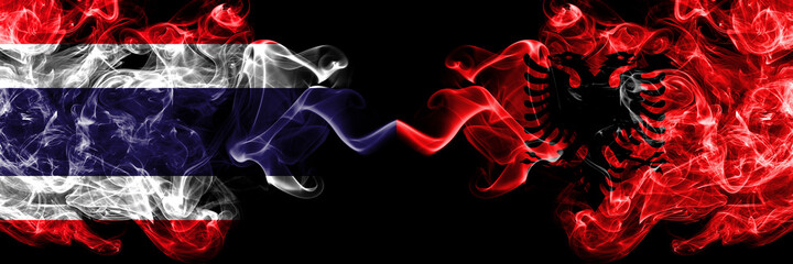 Thailand, Thai vs Albania, Albanian smoky mystic flags placed side by side. Thick colored silky abstract smokes flags.