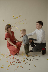 Little boy rejoice at the holiday. The boy has fun and throws some tinsel. Little kid has fun and enjoys the holiday