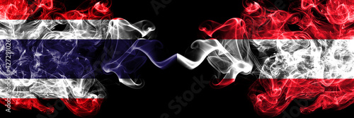 Thailand, Thai vs Austria, Austrian smoky mystic flags placed side by side. Thick colored silky abstract smokes flags.